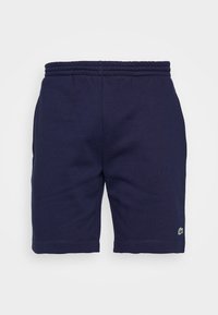 Short bleu marine à taille élastique avec petit logo crocodile vert sur la partie inférieure de la jambe gauche.