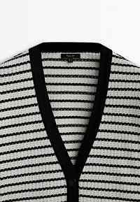 Cardigan tricoté à rayures horizontales noires et blanches avec col en V et fermeture par boutons noirs au centre devant.