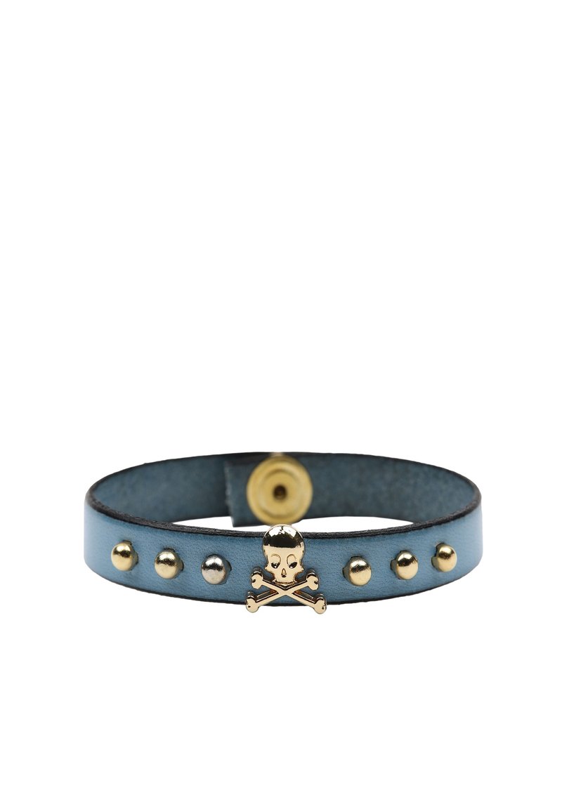 Bracciale in pelle blu con dettaglio di teschio e ossa incrociate in tonalità dorata. Presenta borchie metalliche e chiusura a scatto. Forma arrotondata, texture liscia.