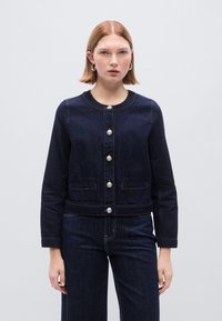 Σκούρο τζιν κοντό μπουφάν με στρογγυλή λαιμόκοψη, ασημένια κουμπιά μπροστά, δύο μπροστινές τσέπες και διακριτικό έντονο ράψιμο. Λείο υφή.