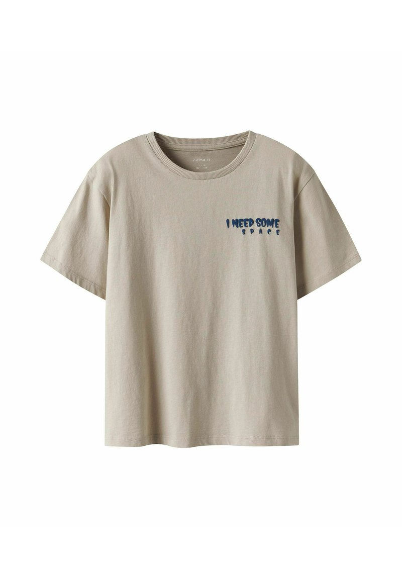 Beżowa bawełniana koszulka z krótkim rękawem i okrągłym dekoltem. Zawiera niebieski napis na piersi "POTRZEBUJĘ TROCHĘ PRZESTRZENI."