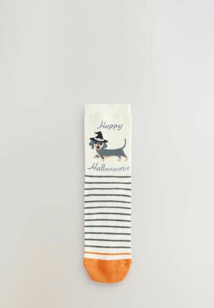 White socks with horizontal black stripes and an orange toe. Features a cartoon dachshund in a witch's hat with "Happy Hallowseenie" text.