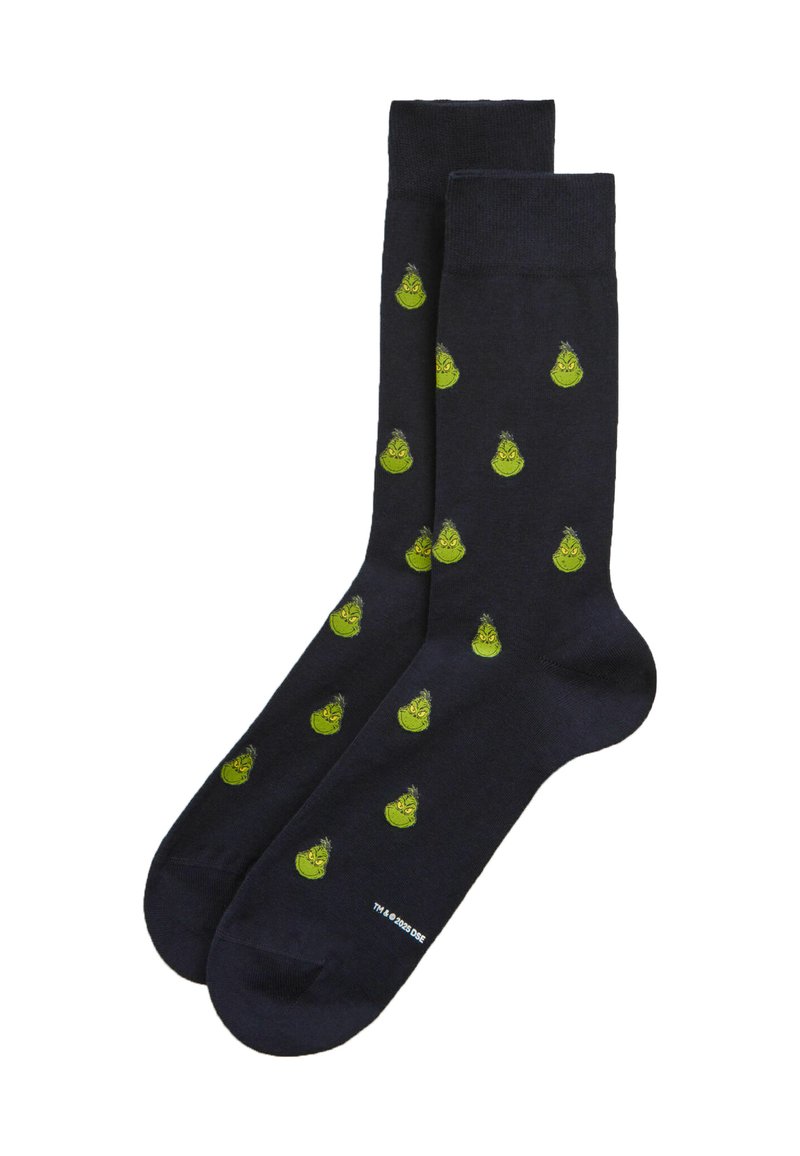 Černé kotníkové ponožky s opakujícím se vzorem malých zelených tváří Grinche.