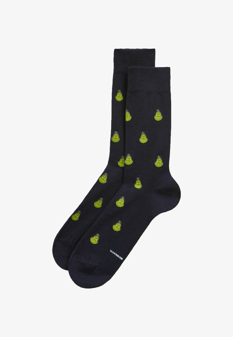 Černé kotníkové ponožky s opakujícím se vzorem malých zelených tváří Grinche.