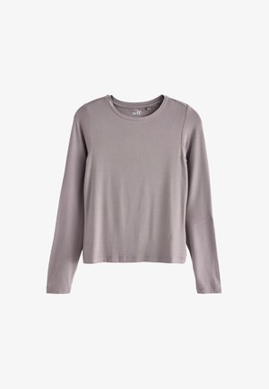 Top cu mâneci lungi, de culoare gri deschis, realizat dintr-un material moale și elastic. Are un guler rotund și o croială lejeră, cu detalii subtile de cusătură.