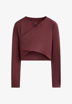 Burgundy long-sleeve cropped top with ribbed texture, wrap design, and a rounded neckline. Features smooth stitching and finished hems.