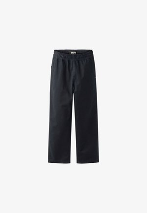 Mustad, laiad jalad, mis on valmistatud kergest kangast. Omab elastset vöökoht ja küljetaskuid. Sile tekstuur, ilma nähtavate mustrite või aktsentideta.