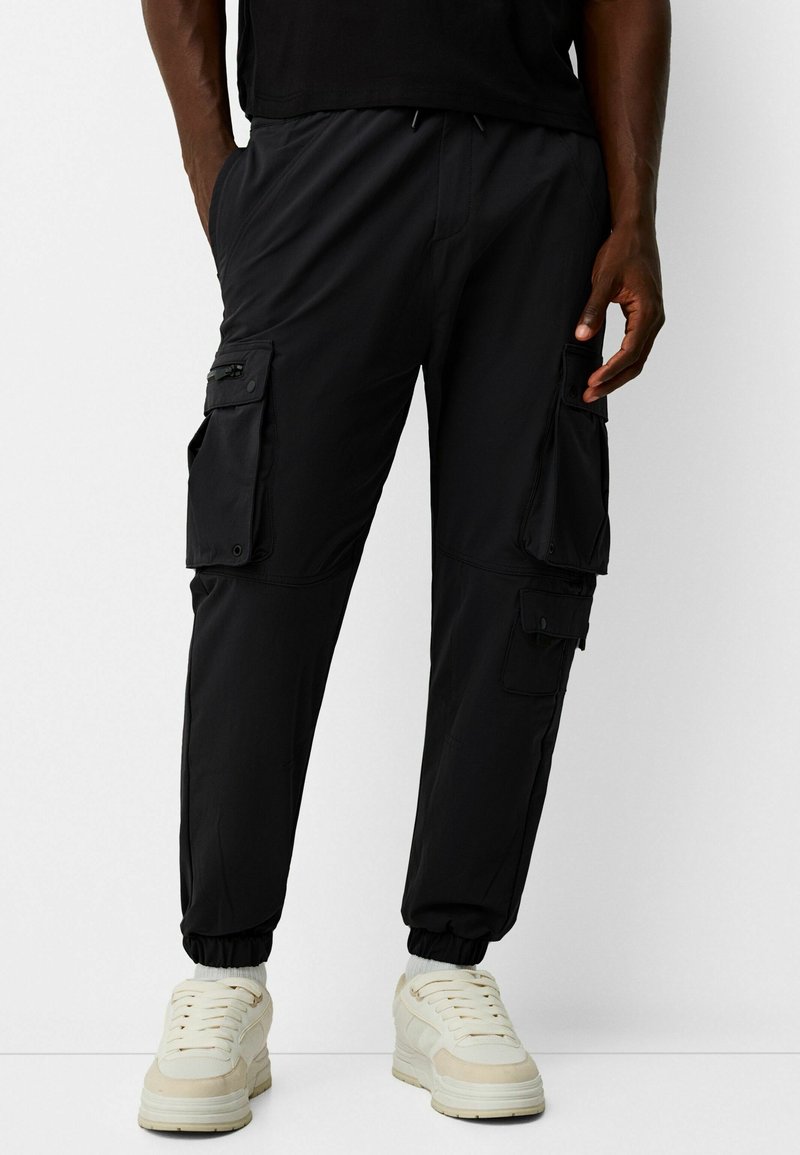 Bershka Pantalones cargo black denim/denim negro (Segunda mano