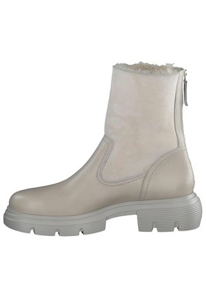 Botte beige clair mi-mollet avec semelle en caoutchouc épaisse, fermeture éclair latérale, et doublure en polaire douce visible au niveau de l'ouverture supérieure.