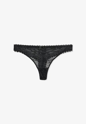 Culotte en dentelle noire avec des bords festonnés, un motif floral et un petit détail en satin en forme de nœud à l'avant. Texture douce et délicate.
