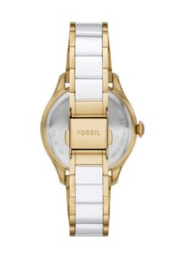 Montre-bracelet dorée avec un bracelet en céramique blanche. Boîtier rond avec un fond transparent, portant le nom de la marque "Fossil" sur le fermoir.
