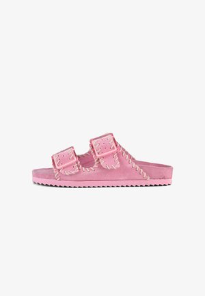 Pink suede slide sandal with double buckle straps, contrasting stitched accents, and a textured, serrated outsole.