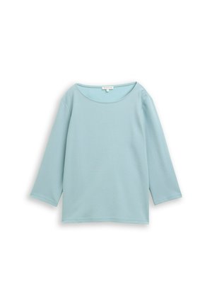 Lichtblauw, langärmelig top met ronde hals, ribbelstructuur en een ontspannen pasvorm. Kenmerkt zich door subtiele stiksels overal.