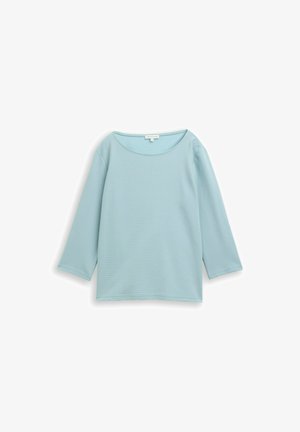 Hellblaues langärmliges Oberteil mit Rundhalsausschnitt, gerippter Textur und lockerer Passform. Verfügt über subtile Nähdetails überall.