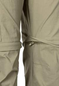 Lightweight, textured, olive-green jacket with a zippered pocket on the side and a tied waist, featuring a relaxed fit and practical design.