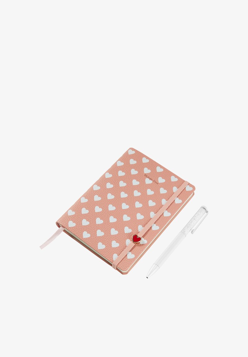 Quaderno rosa con texture e motivo a cuori bianchi, dotato di chiusura elastica con un dettaglio a cuore rosso. Accompagnato da una penna bianca.