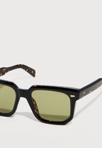 Black rectangular sunglasses with tortoiseshell-patterned arms and green tinted lenses on a white background.