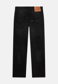 Jeans din denim negri cu croială drept, având două buzunare pe spate, cusături subtile și o etichetă din piele maro cu marca la talie.