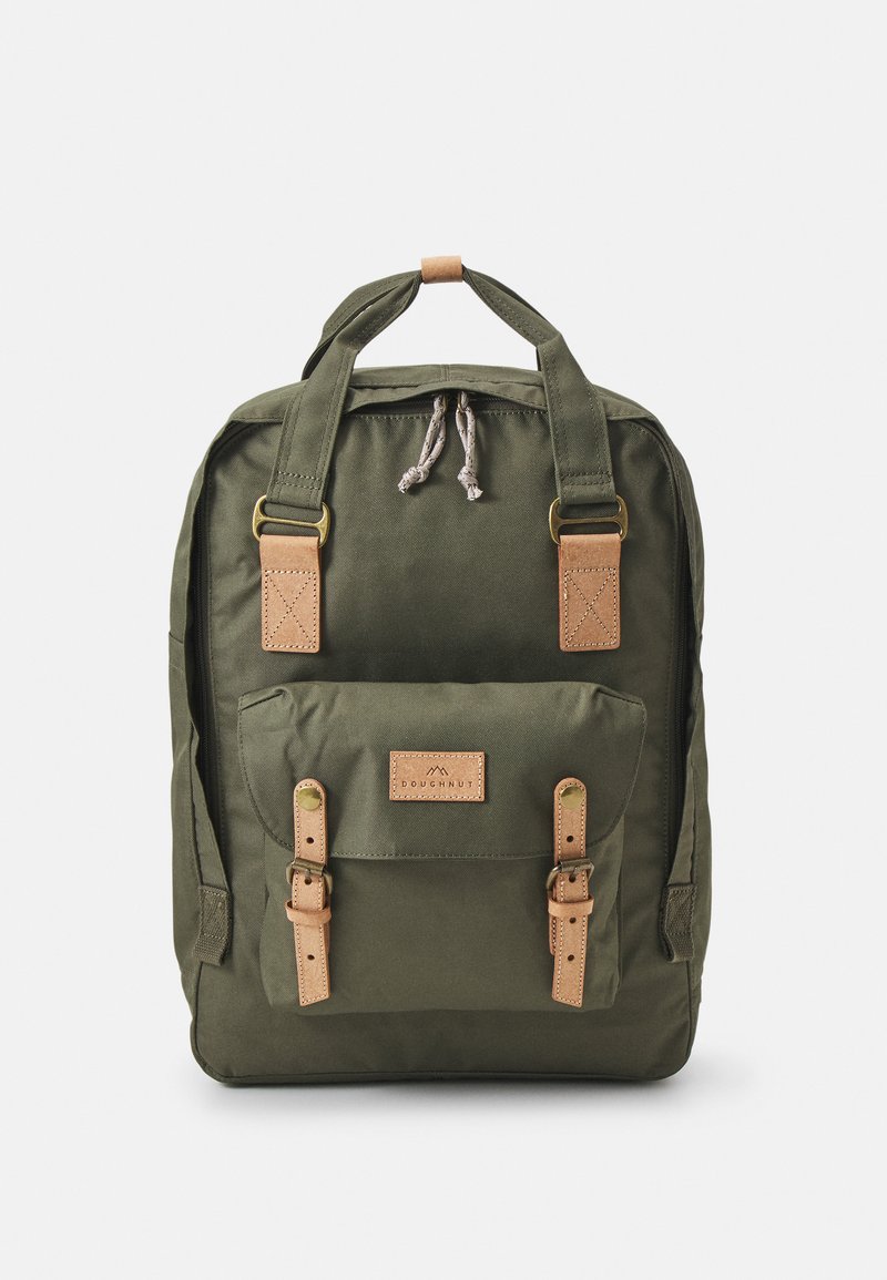 Olive green canvas backpack with leather accents, adjustable straps, top handle, front pocket with buckle closures, and logo patch.