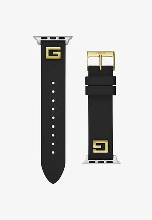 Juodas silikono laikrodžio dirželis su auksiniais elementais, kuriame išsiskiria ryškus 'G' logotipas ir sidabriniai akcentai gale. Nurodyti reguliavimo skylutės.