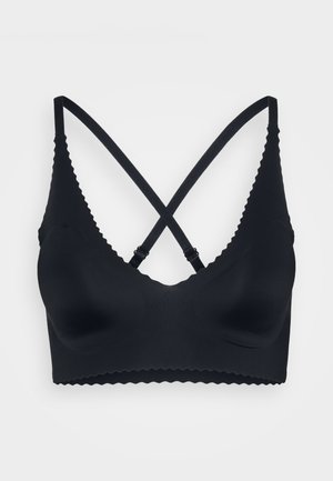 Sort trådløs bralette med bølget kant, glat tekstur, justerbare krydsede stropper og runde skåle for komfort.