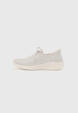 Light gray athletic shoe with a textured mesh upper, laces, and a white sole. Features a blue logo near the heel and a streamlined design.