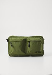 Olive green rectangular bag made of durable fabric, featuring two front zip pockets and a logo. Smooth texture with contrasting black zippers.