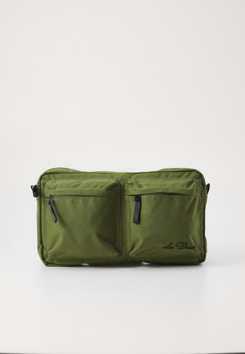 Olive green rectangular bag made of durable fabric, featuring two front zip pockets and a logo. Smooth texture with contrasting black zippers.