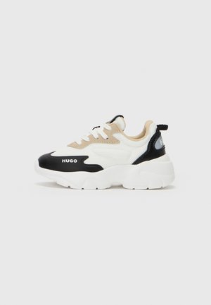 Black, white, and beige sneaker with textured fabric, padded tongue, prominent sole, and logo detail on the side. Lace-up closure.
