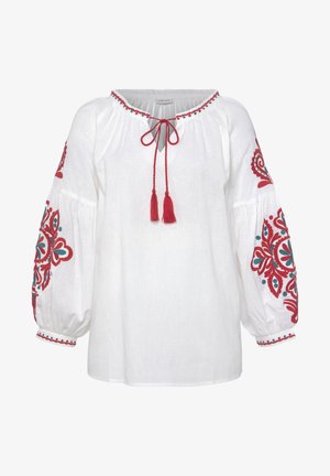 Witte blouse met rode en turkooise bloemenborduursels op ballonmouwen. Beschikt over een ronde halslijn met een halsbandje en franjes.