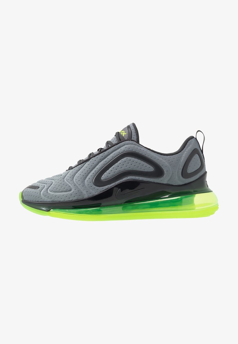 Chaussure de sport grise et noire avec semelle coussinée d'air vert néon et languette à l'arrière, vue latérale sur fond blanc.