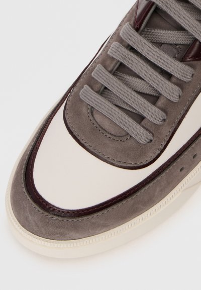 Grey suede sneaker with cream leather accents, round toe, thick grey laces, and burgundy detailing along the edge and eyelets.