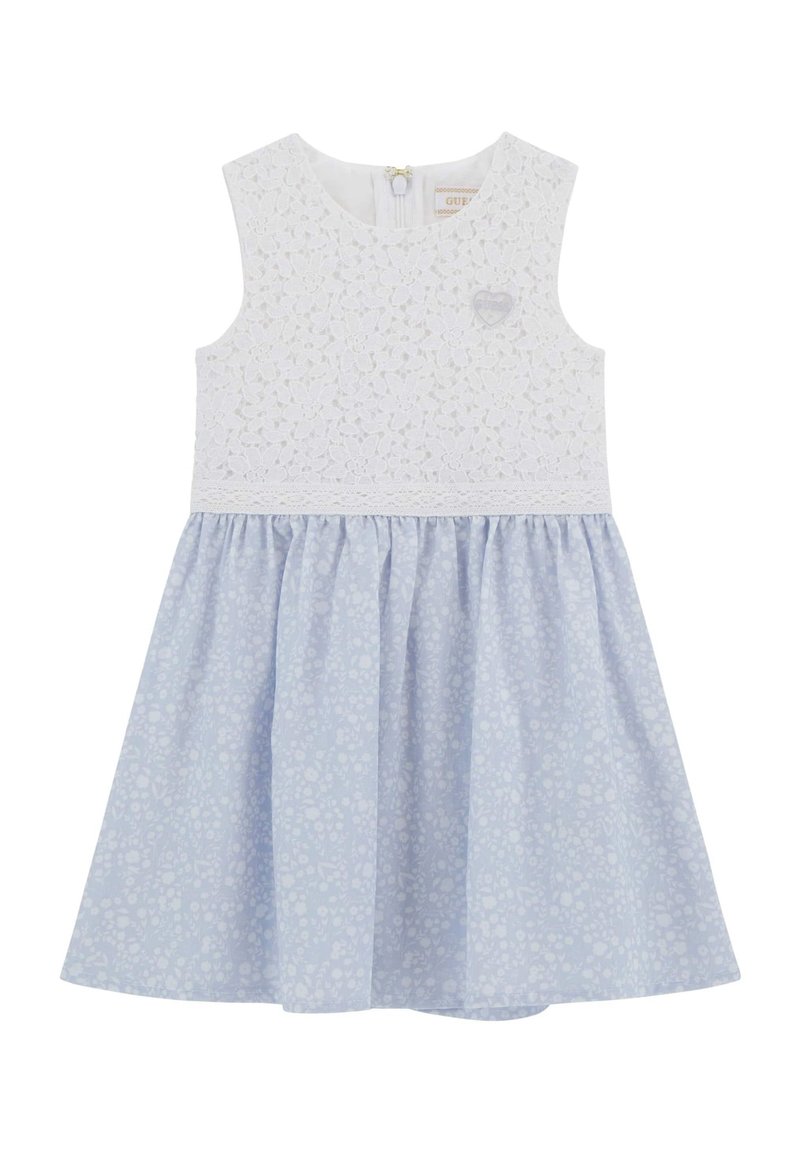 Robe sans manches blanche avec un corsage en dentelle, jupe à motifs floraux bleus et fermeture éclair au dos. Présente un petit détail en forme de cœur sur la poitrine.