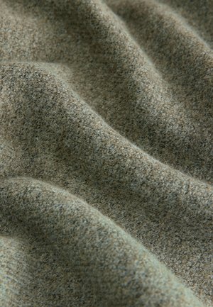 Tkanina z teksturo v umirjenih zelenih odtenkih, z mehkim, tkanim videzom in majhnimi madeži temnejše barve po celotni površini.