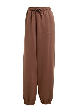 Pantalon de survêtement marron en tissu doux, avec une taille élastique et un cordon de serrage, ainsi que des poignets aux chevilles. Marquage subtil sur le côté.
