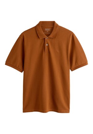 Kortärmad pikétröja i rostorange, med klassisk krage, tre knappar och en liten broderad logotyp på bröstet. Mjuk tygstruktur.