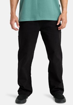 Black cargo pants featuring a straight-leg design, sturdy fabric, dual side pockets, and a smooth texture, paired with black footwear.