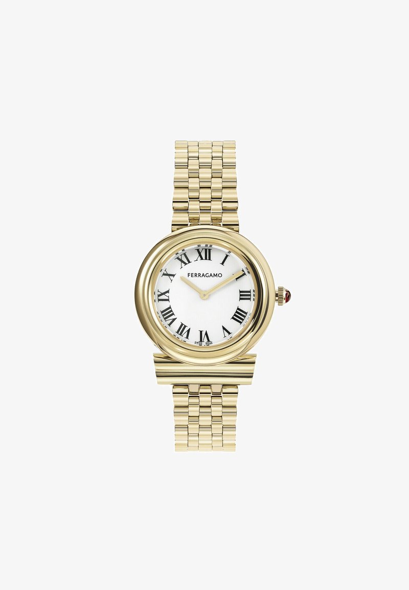 Kuldne käekell ümmarguse korpusega, valge dialekesega, mustade rooma numbritega ja siledast lingist käevõru. Kroonil on punane aktsent.