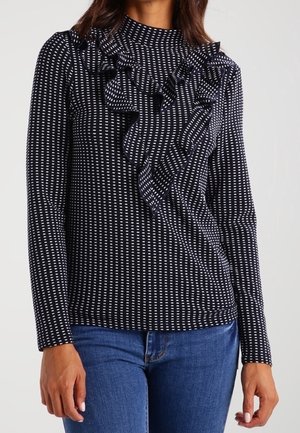 Langärmliges Oberteil in Marineblau mit weißen vertikalen Streifen, mit hohem Ausschnitt und einem gerafften asymmetrischen Vorderteil. Strukturierter Stoff.