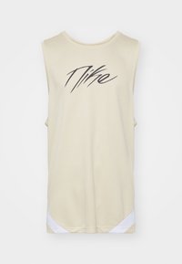 Lichtbeige sportjersey zonder mouwen van een textuur geperforeerde stof. Beschikt over een zwart Nike-logo op de achterkant en een witte accent bij de zoom.