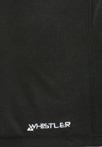 Tissu en tricot noir avec un motif texturé, comportant un logo brodé "WHISTLER" blanc au bord inférieur.