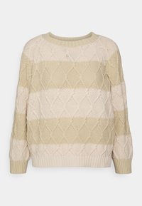 Maglione lavorato a maglia spessa con motivi a diamante in colori beige e crema a righe. Presenta un collo rotondo e polsini a coste sulle maniche.