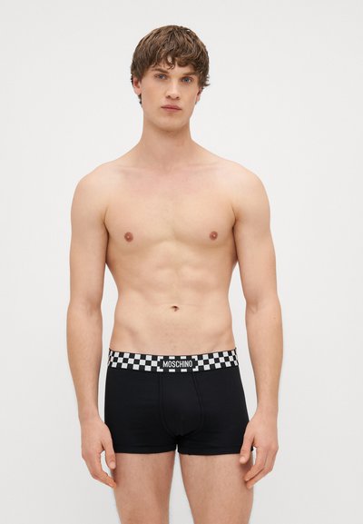 Black boxer briefs with a checkerboard elastic waistband featuring "MOSCHINO" in bold lettering; snug fit and smooth texture.