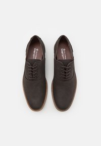 Brown lace-up shoes with a smooth surface and subtle perforated pattern, featuring a rounded toe and contrasting stitched trim along the sole.