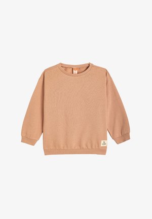 Sweatshirt marron clair en coton, avec un col rond, des poignets côtelés et une étiquette "Be Kind" sur le bas à gauche. Texture douce.