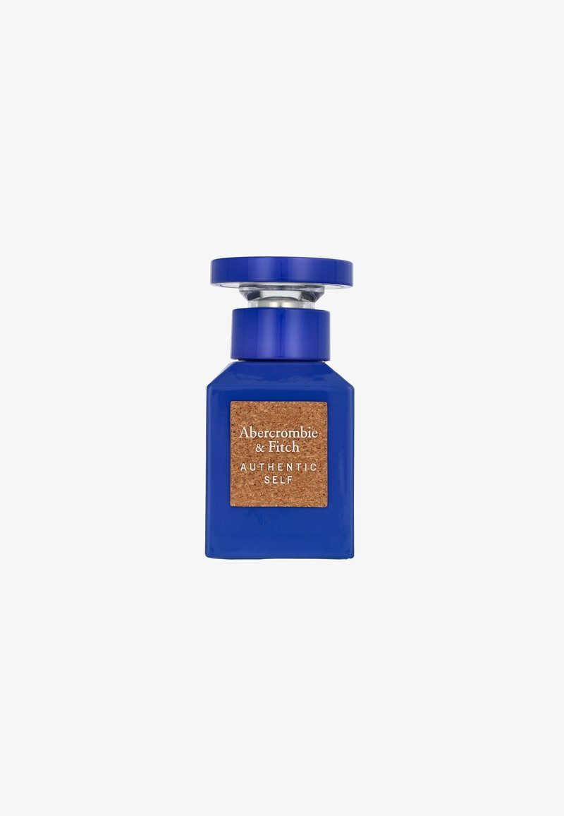 Blue glass perfume bottle with a cork accent and silver cap, featuring a label that reads "Abercrombie & Fitch AUTHENTIC SELF."