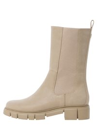 Beige ankle boot with smooth leather finish and elastic side panels. Chunky rubber sole provides traction and stability. Simple design.