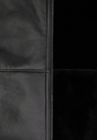 Black leather jacket featuring a smooth texture, a central zipper, and contrasting sections of plush material for added detail.