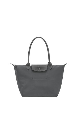 Black tote bag with long handles, top zipper, and front flap pocket with button closure on a white background.