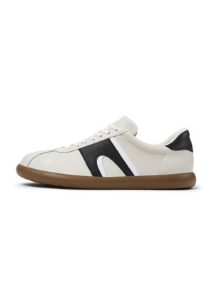 White sneaker with black and white accents and a brown sole, shown from the side to highlight its design and shape.
